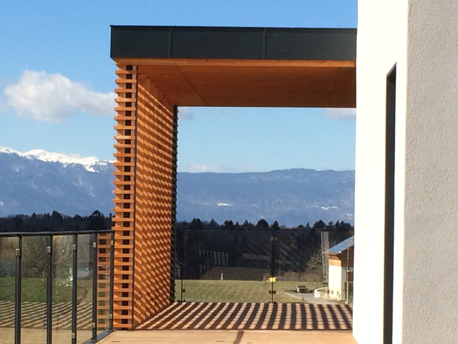 Installation de bardage en bois sur l'extérieur d'une maison avec vue sur la montagne.